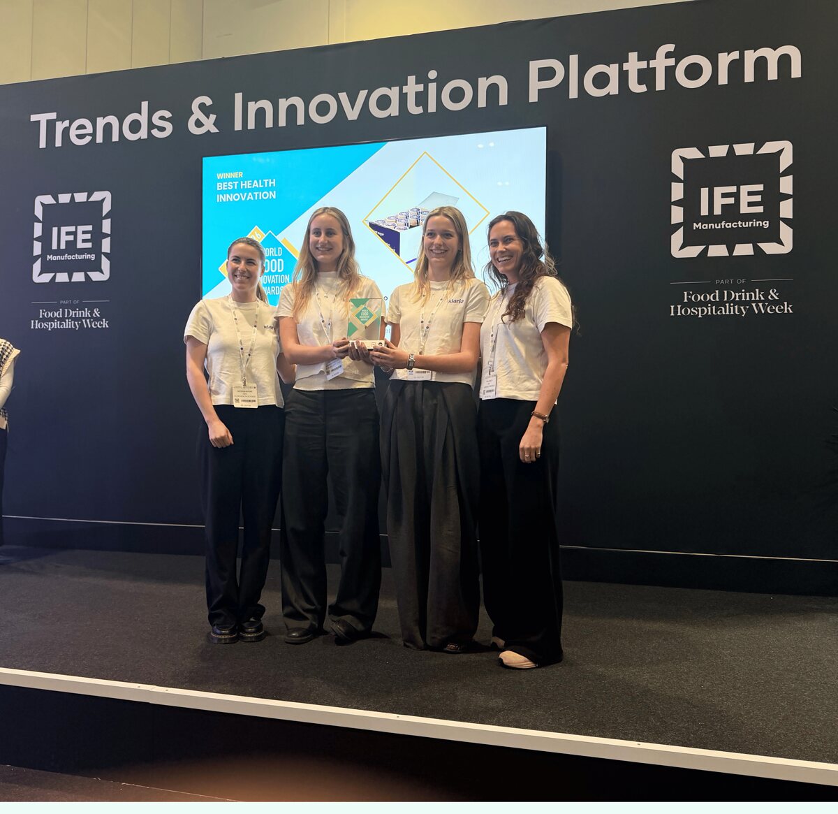 The Flow Health Science team accepting the Best Health Innovation award at the World Food Innovation Awards 2026 — four team members on stage in front of a "WINNER: Best Health Innovation" slide